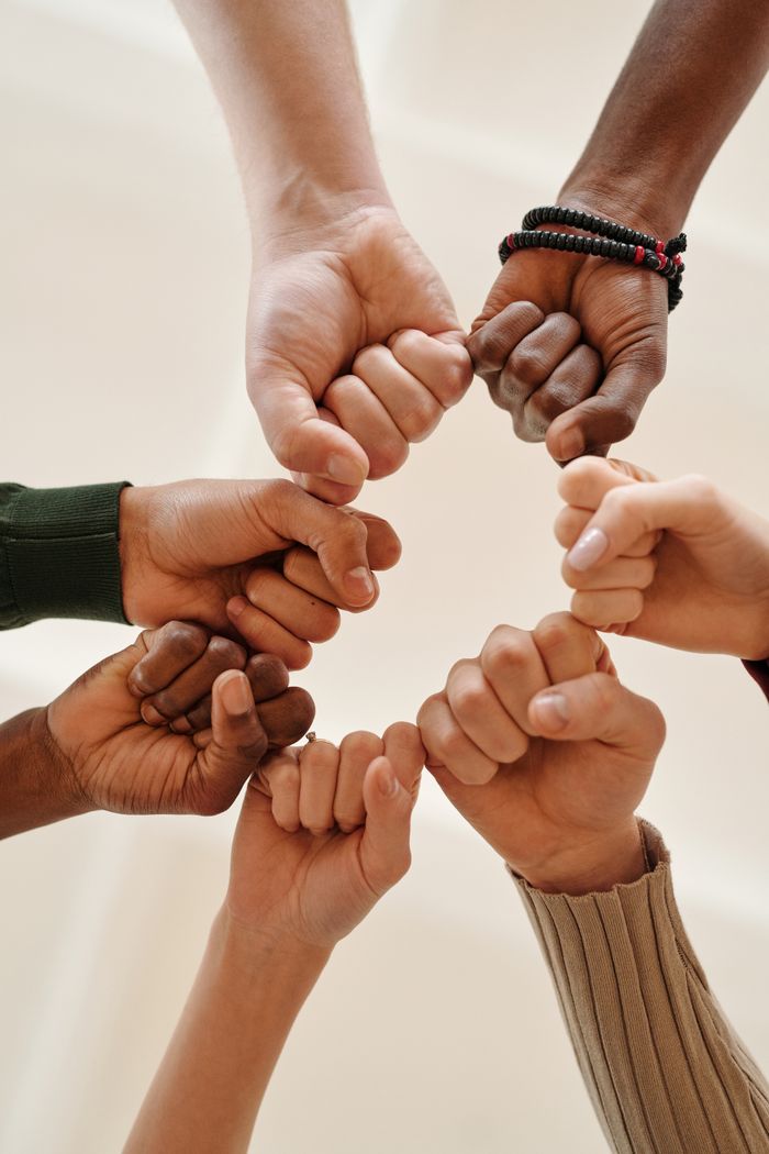 The Art of Drawing Readers In: Your attractive post title goes here Hands of diverse people fist bumping, symbolizing unity and teamwork.